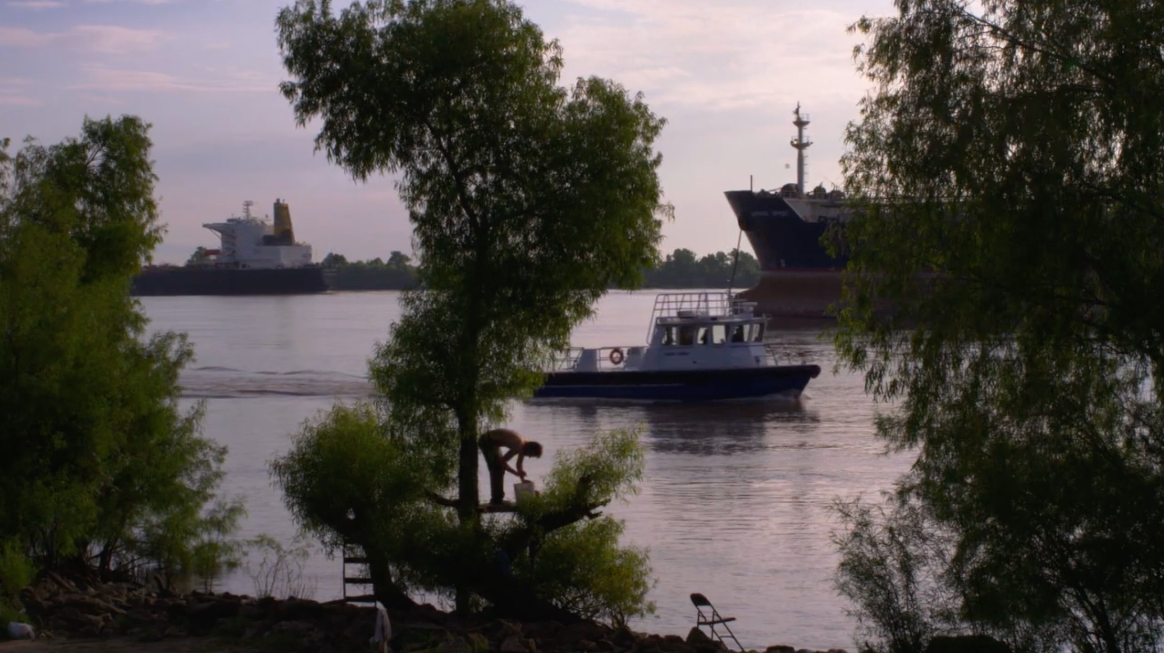 A still from Jeff Whetstone's The Batture Ritual (2018) depicting a boat on the Mississippi River